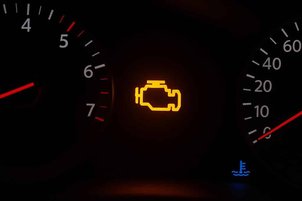 CHECK ENGINE LIGHT ON? HERE’S WHAT IT COULD REALLY MEAN Illuminated check engine light on a car dashboard indicating potential vehicle issues